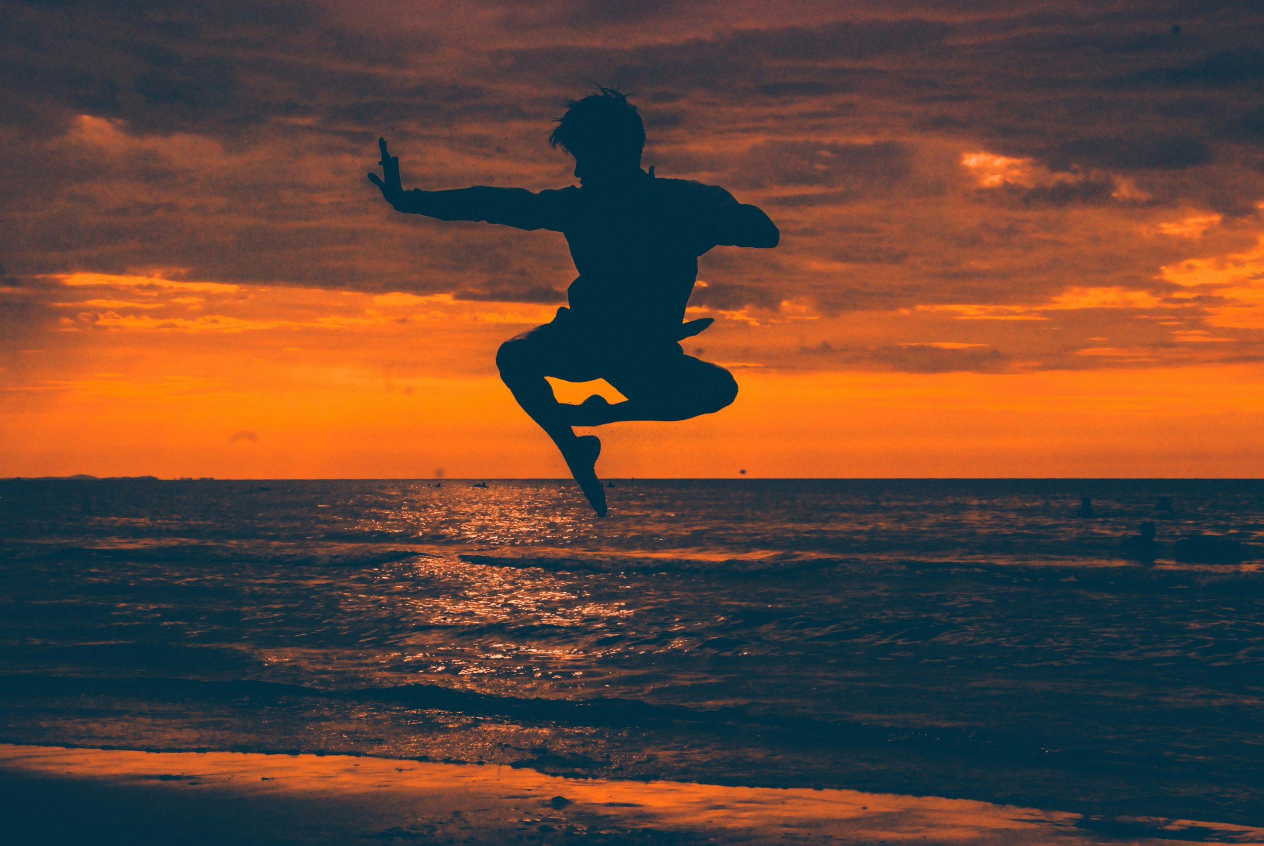 Silhouette of a Kung Fu (功夫) jump at sunset on a beach