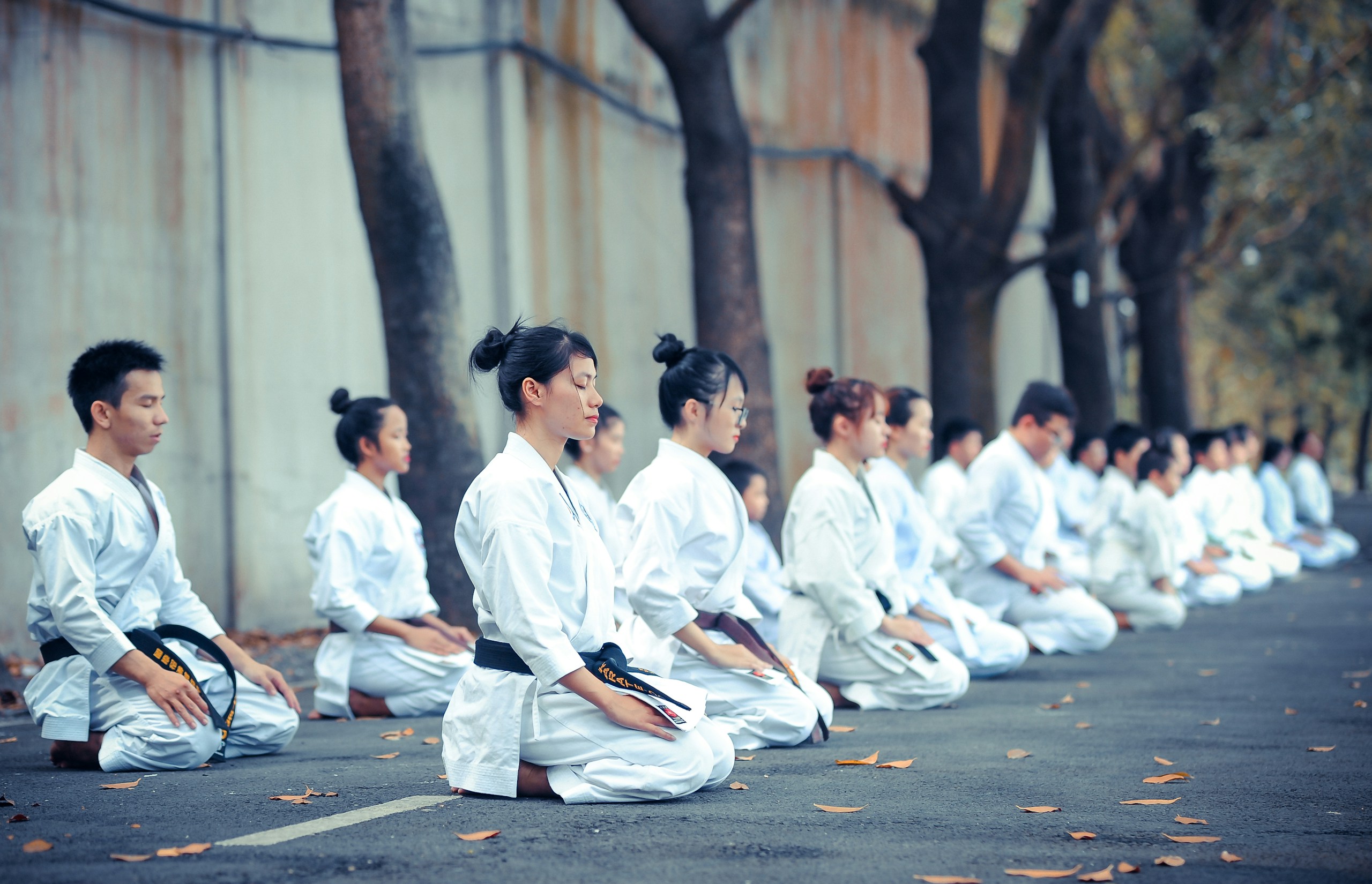 A group of Gui Yi martial arts students training together in a calm, focused, community atmosphere