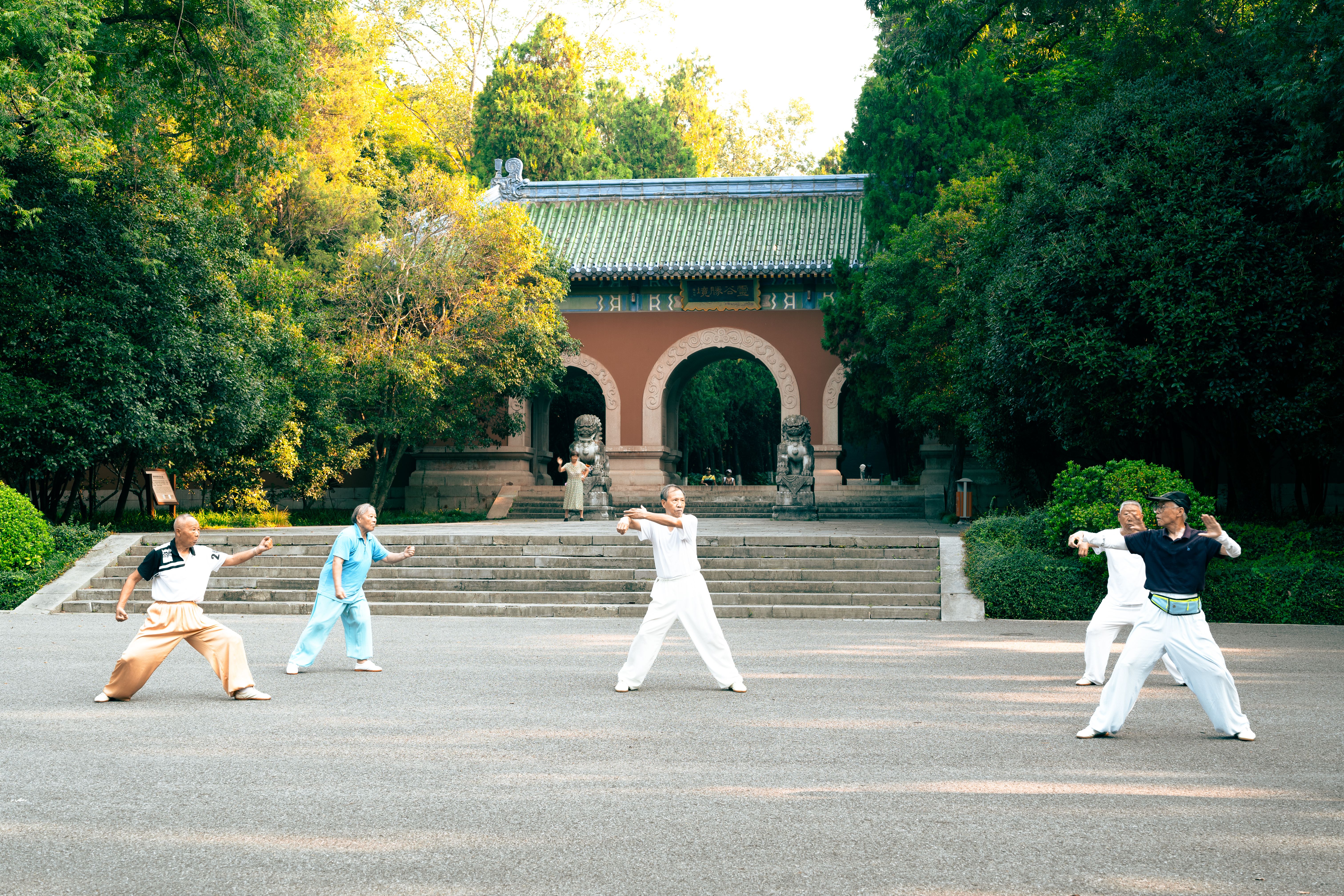 Tai Chi Practice at a Traditional Chinese Temple Practitioners performing Tai Chi (太極拳) in the courtyard of a traditional Chinese temple, representing the living heritage of Chinese martial arts lineage